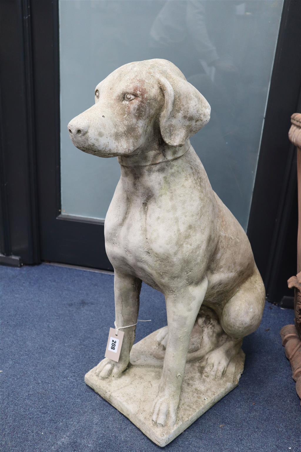 A pair of reconstituted stone garden ornaments of seated hounds, height 70cm